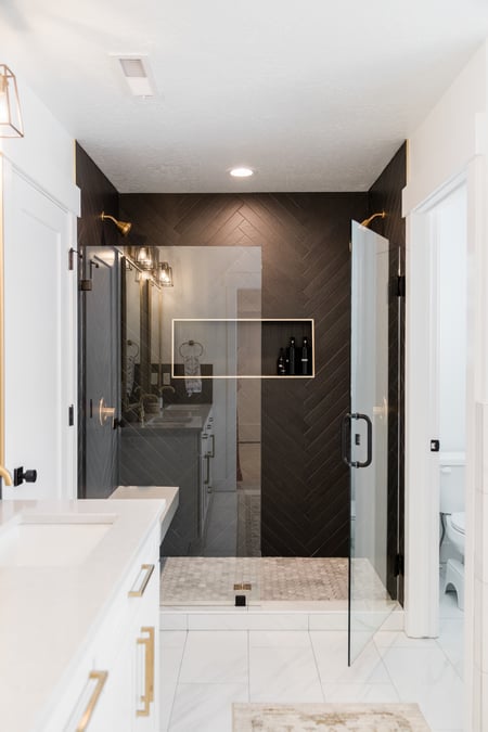 Walk in shower glass door black herringbone tile