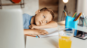 boy bored with doing his homework