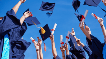 college grads tossing hats