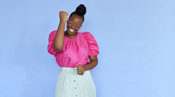 woman in pink shirt celebrating a win