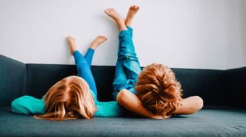 young boy and girl with feet up on wall