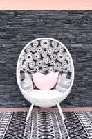 white accent chair with pink heart pillow