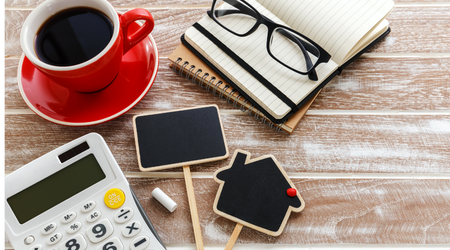 red coffee cup with glasses and calculator