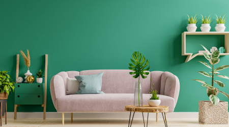light pink sofa in green living room with live plants